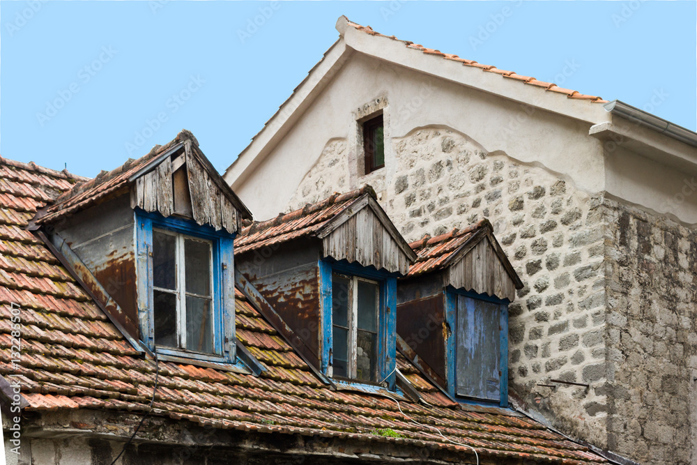 Attic windows in an ancient house in Kotor, Montenegro