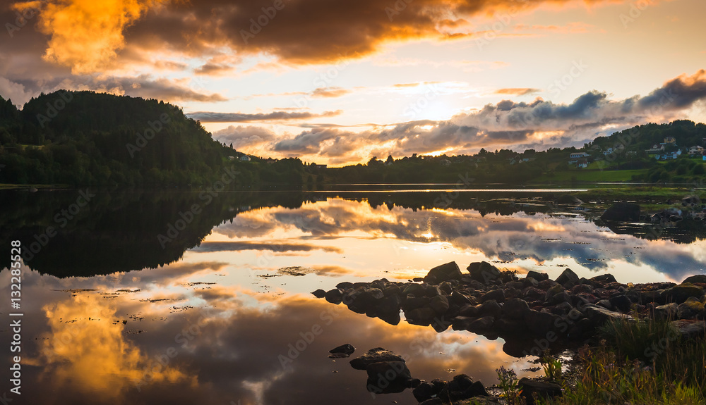 Magnificent panorama of the  sunset with reflection in water. The county of More og Romsdal. Norway