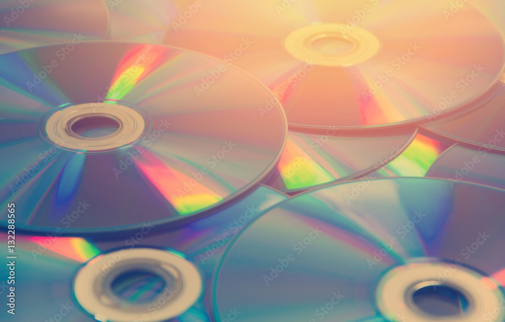 colorful compact discs set of DVD scattered on a table colorful compact discs set of DVD scattered on a table