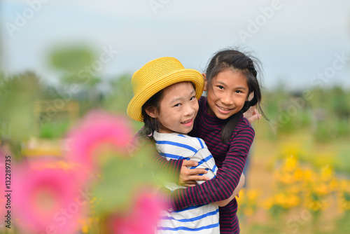 Happy Asian children in flower fields.
