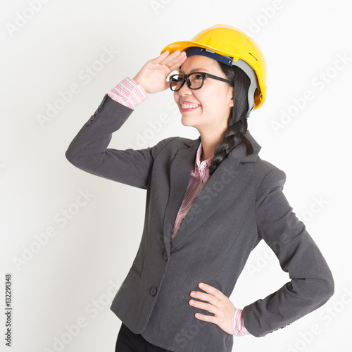 Female engineer looking away