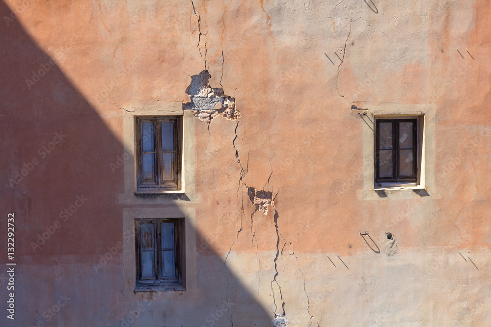 window broken on a red facade