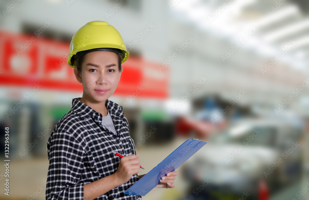 Asian women engineers and technicians mechanic are checking and inspectingthe list on the board of a car in auto repair shop Asian women engineers and technicians mechanic are checking and inspectingthe list on the board of a car in auto repair shop