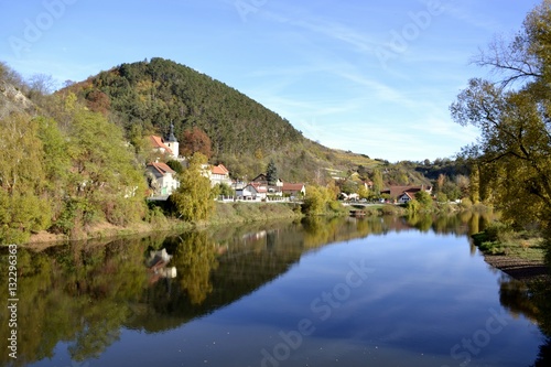 River with water reflections and houses 
