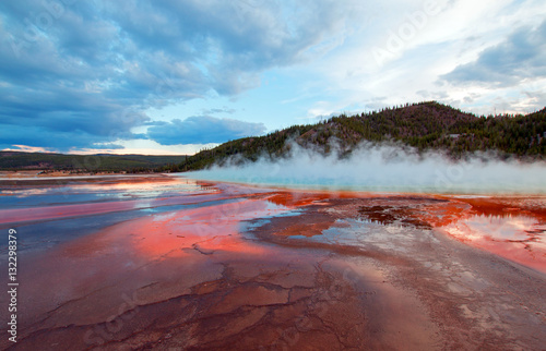 The Grand Prismatic Spring at sunset in the Midway Geyser Basin along the Firehole River in Yellowstone National Park in Wyoming