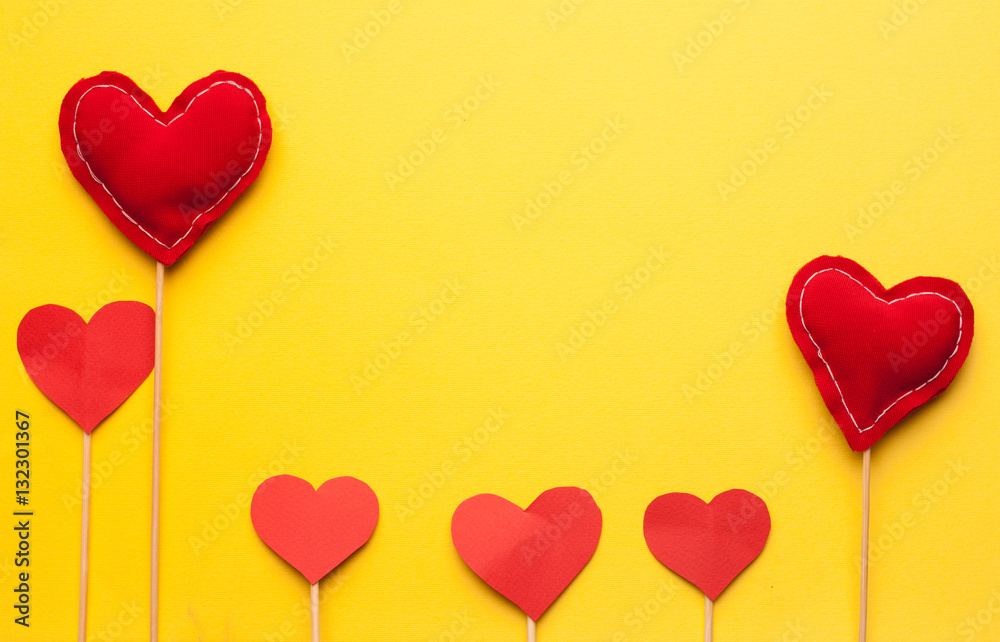 red hearts on a stick, yellow background