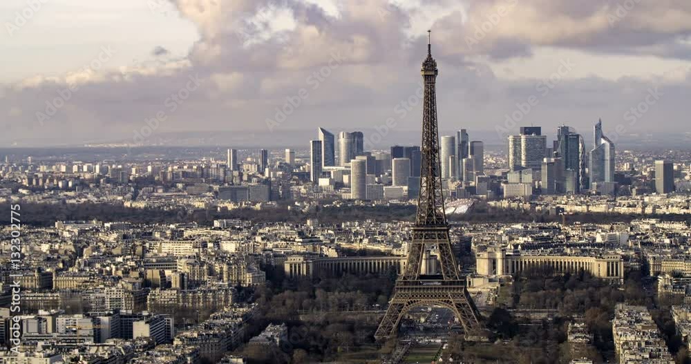 Aerial panning time lapse view of the Eiffel tower and the financial district of La Defense in Paris
