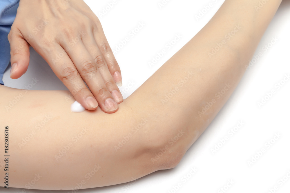 Apply small amount of body lotion to moisture the body skin on white background isolated