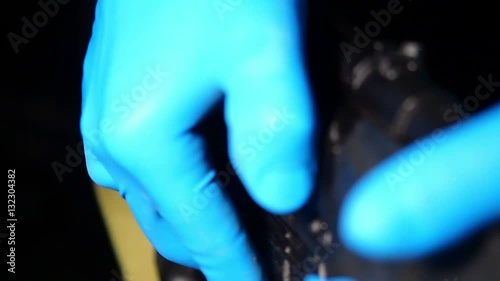 Male hand attaching cartridge to automatic rifle and put safety on. Closeup.