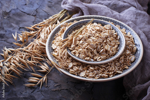 Oat flakes in bowl and spikelets