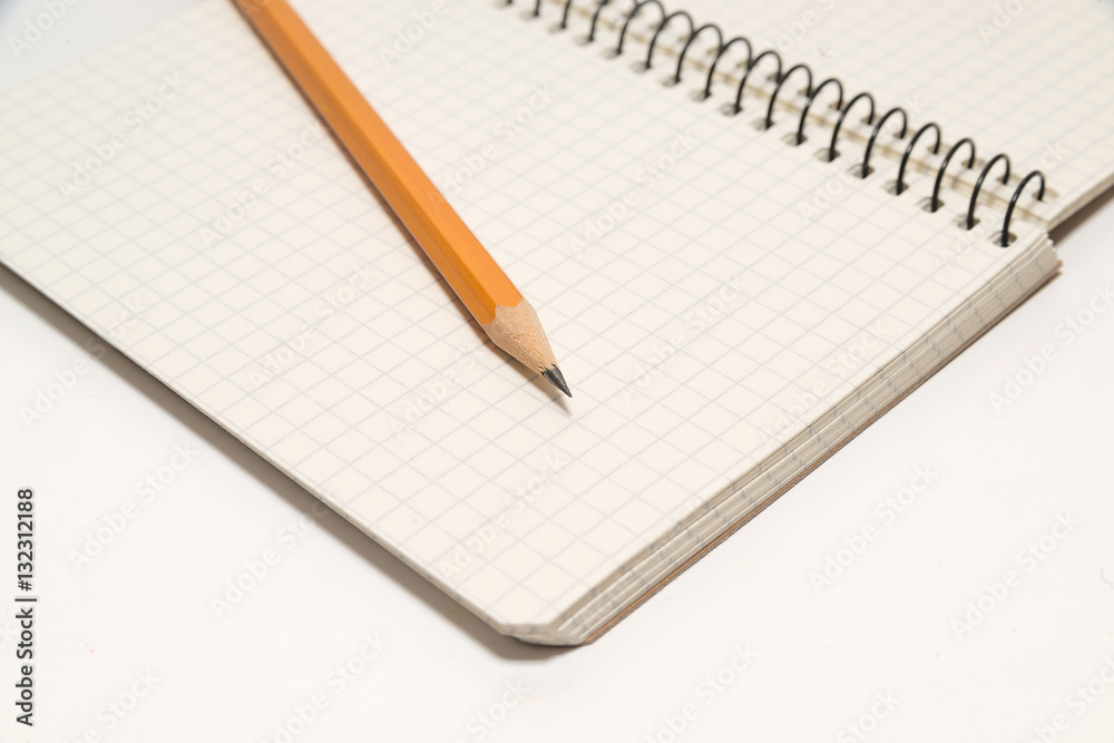 Pencil on the pages of an open notebook for records Pencil on the pages of an open notebook for records