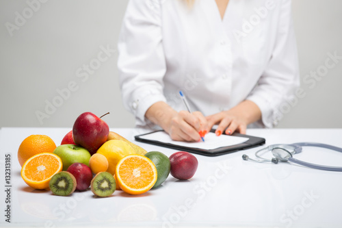 Healthy life style concept, doctor writing, diet and losing weight photo
