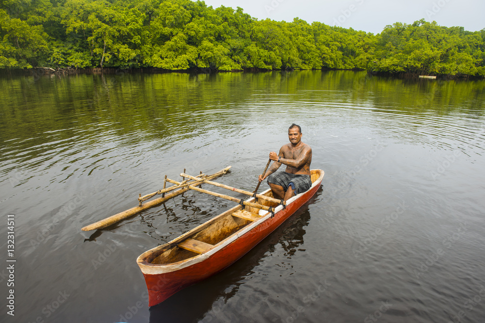 Man in his dugout canoe, Kosrae, Federated States of Micronesia, South Pacific Man in his dugout canoe, Kosrae, Federated States of Micronesia, South Pacific