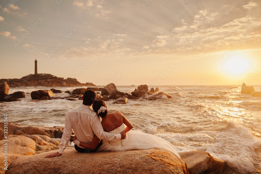 honeymoon couple relax on sunset beach