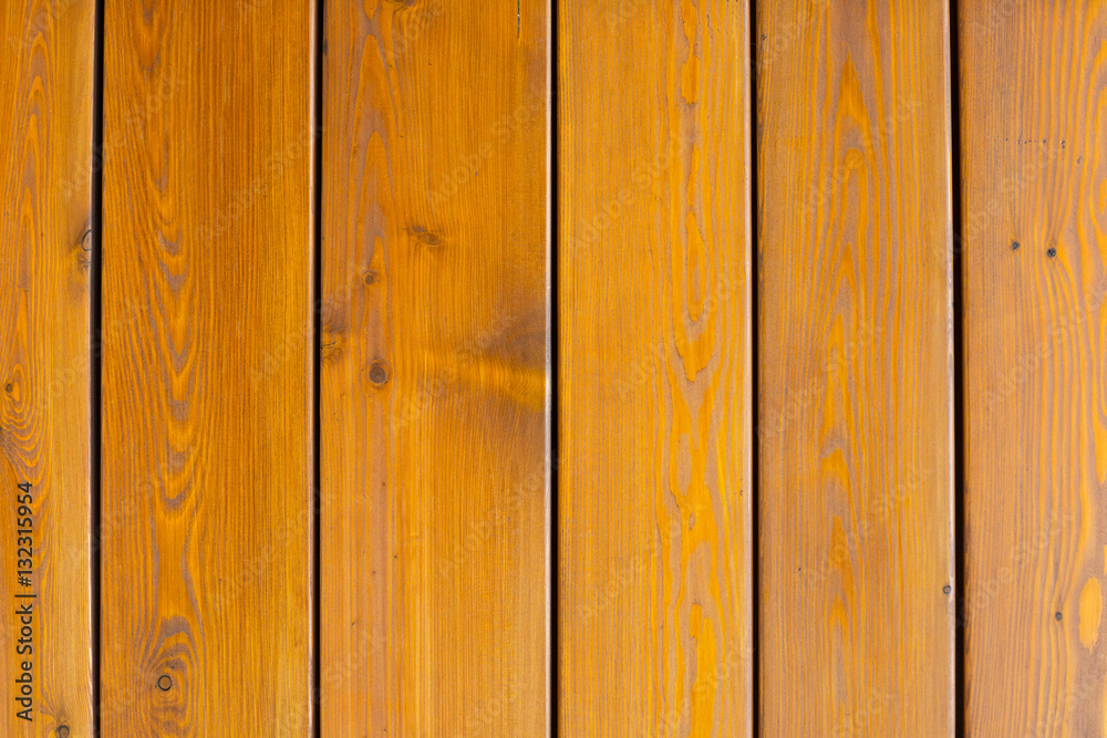 Natural wooden orange background, rough texture of hardwood planks for floors and walls in the construction of the house Natural wooden orange background, rough texture of hardwood planks for floors and walls in the construction of the house