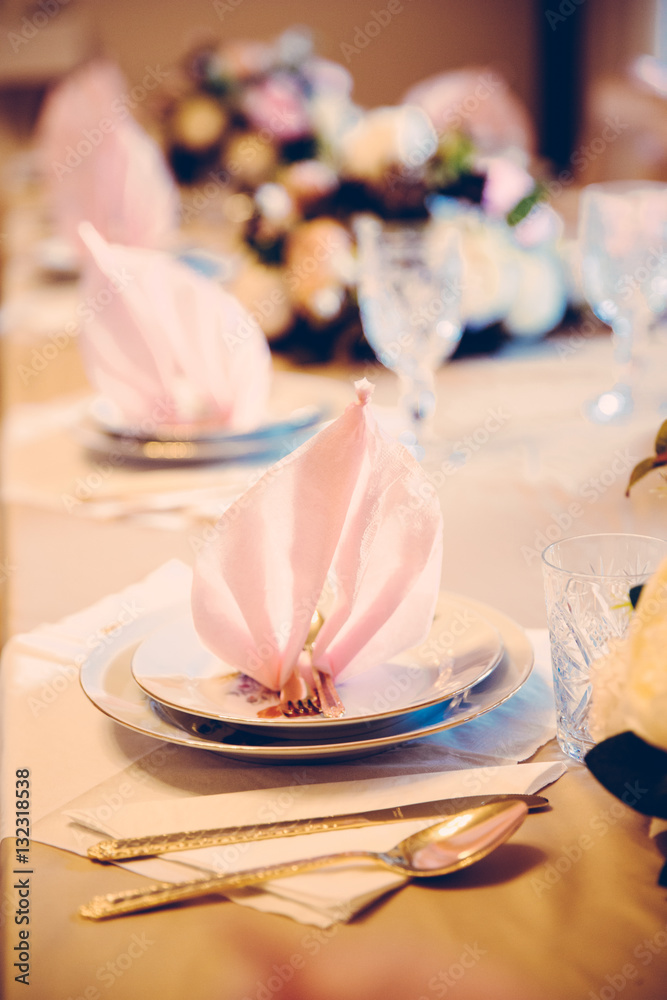 Elegant table setting with beautiful flowers and napkins, vertical vintage Elegant table setting with beautiful flowers and napkins, vertical vintage