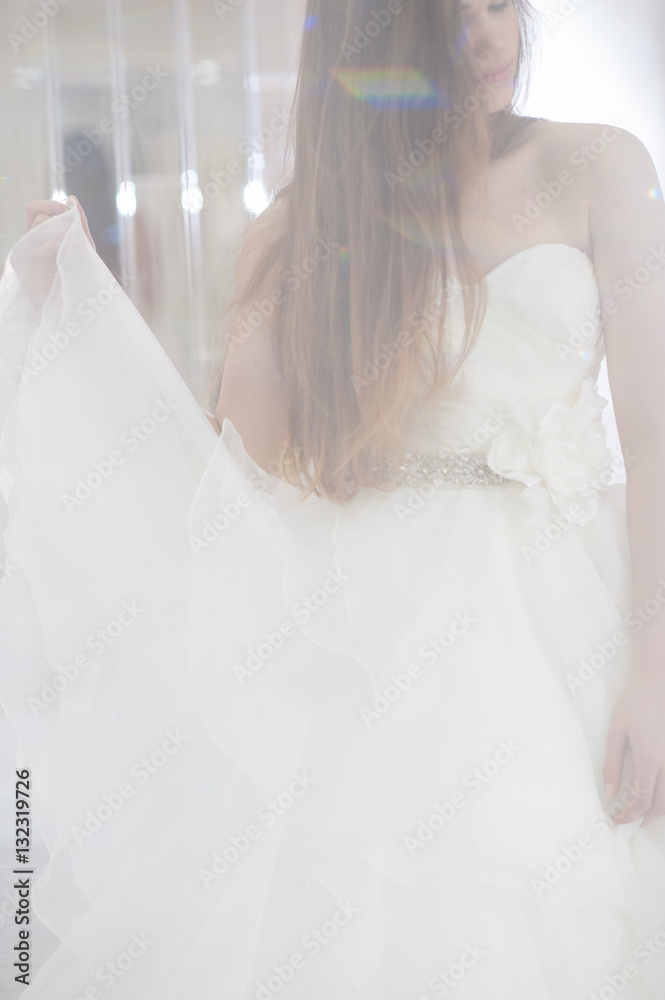 Wedding bridal white dress in the showroom fashion, abstract, vertical Wedding bridal white dress in the showroom fashion, abstract, vertical