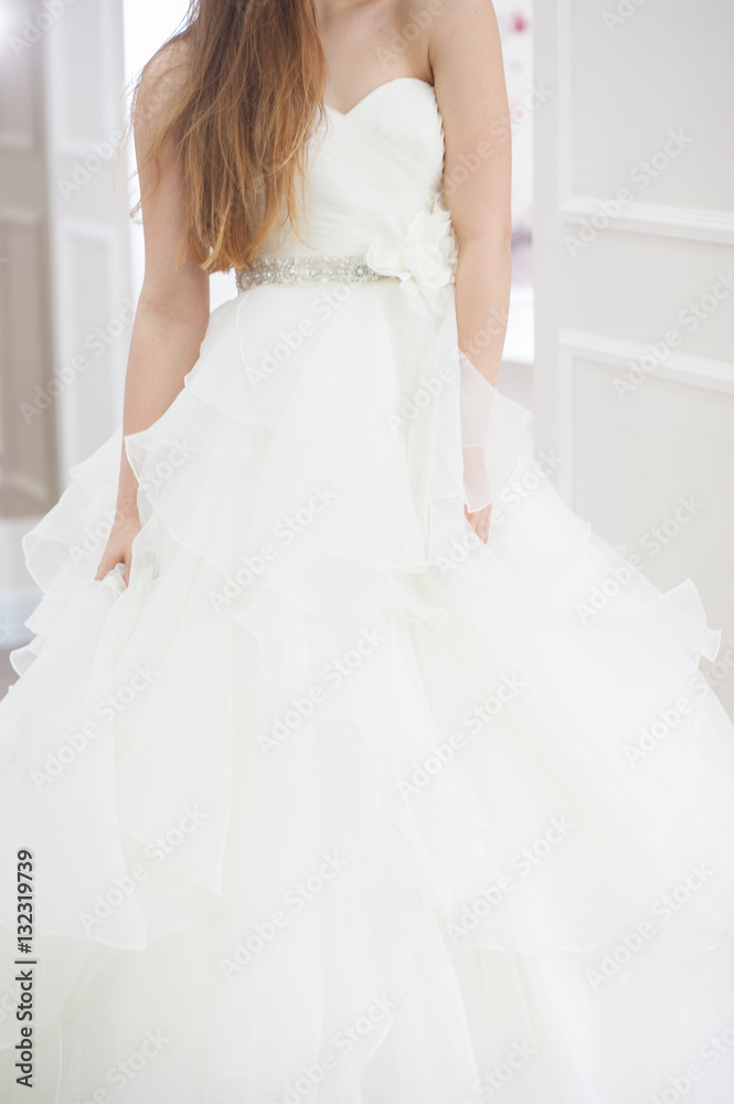 Wedding bridal white dress in the showroom fashion, abstract, vertical Wedding bridal white dress in the showroom fashion, abstract, vertical