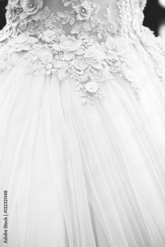 White long bridal dress with details of lace in showroom, textile, vertical black and white White long bridal dress with details of lace in showroom, textile, vertical black and white