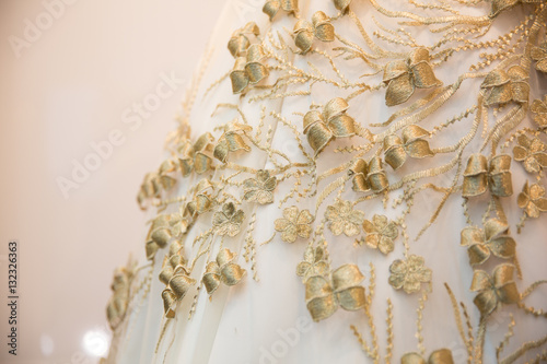 Texture of cloth with details of golden flowers and leaves, luxury