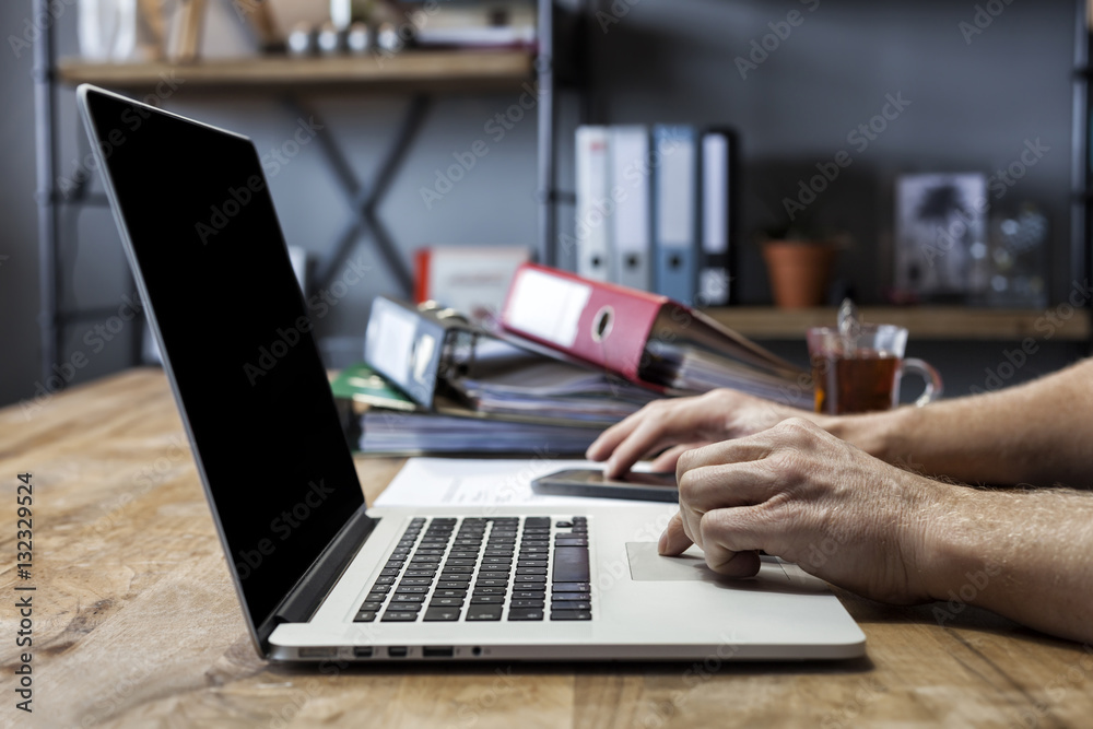 Side view shot of a man's hands using smart phone in interior Side view shot of a man's hands using smart phone in interior