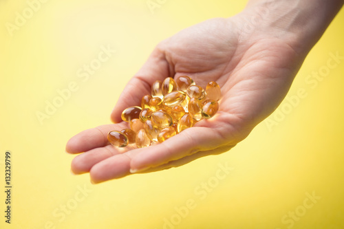 Hands holding omega 3 pills