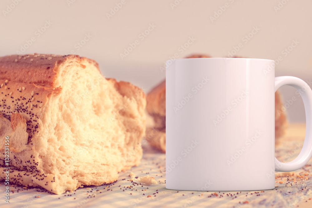 White blank coffee mug to add custom design/quote. Next to a loaf of bread. White blank coffee mug to add custom design/quote. Next to a loaf of bread.