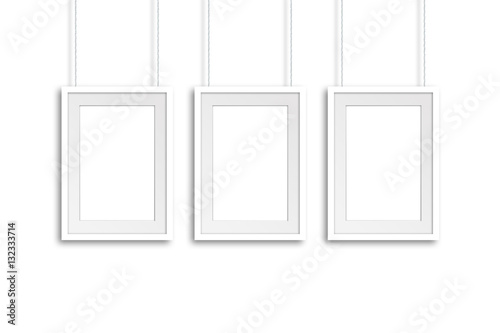 Three white frames hanging on cords, gallery style mock up