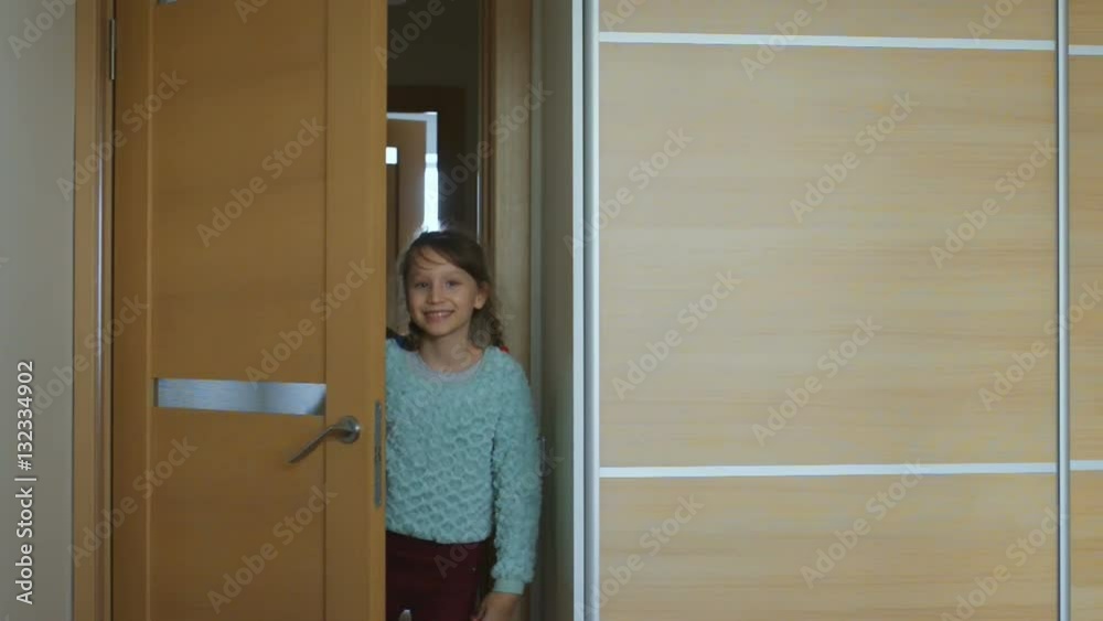 Lovely little girl opening indside door Lovely little girl opening indside door