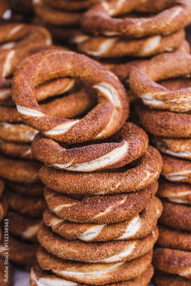 Turkish bagel simit close up. Fresh baked pastries for sale on t Turkish bagel simit close up. Fresh baked pastries for sale on t