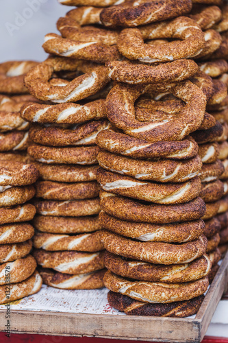 Fototapeta Naklejka Na Ścianę i Meble -  Turkish bagel simit close up. Fresh baked pastries for sale on t
