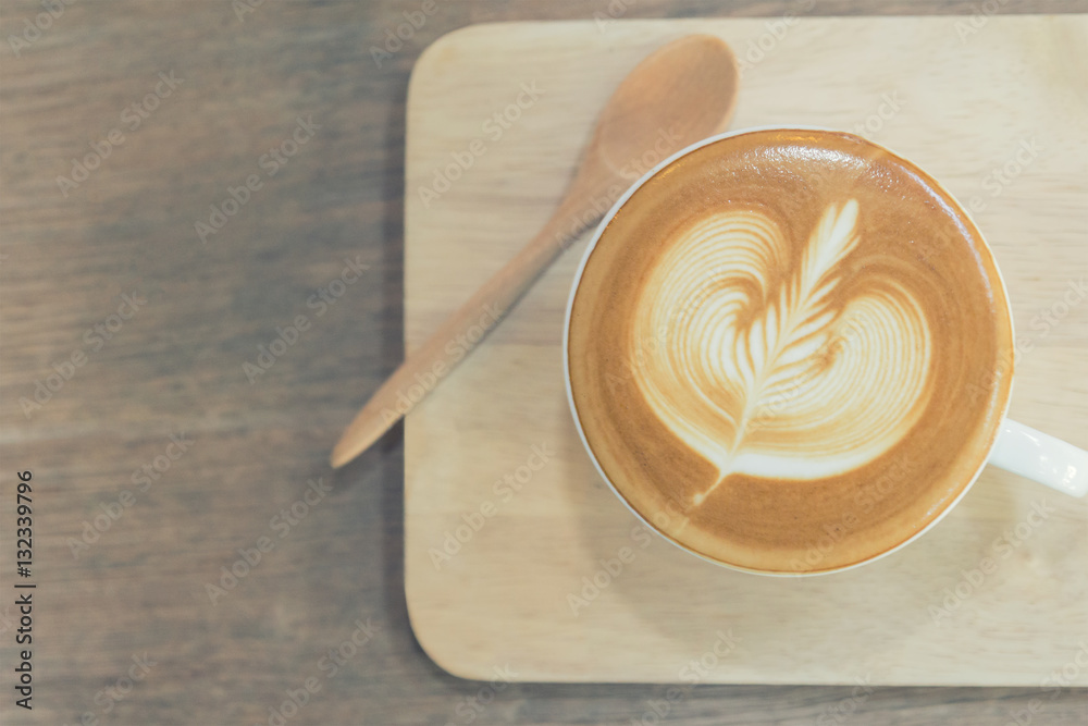 Art of latte coffee, cup of coffee on wooden board