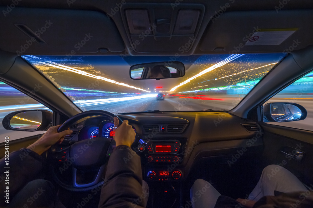 Night road view from inside car natural light street and other cars is motion blurred. Night road view from inside car natural light street and other cars is motion blurred.