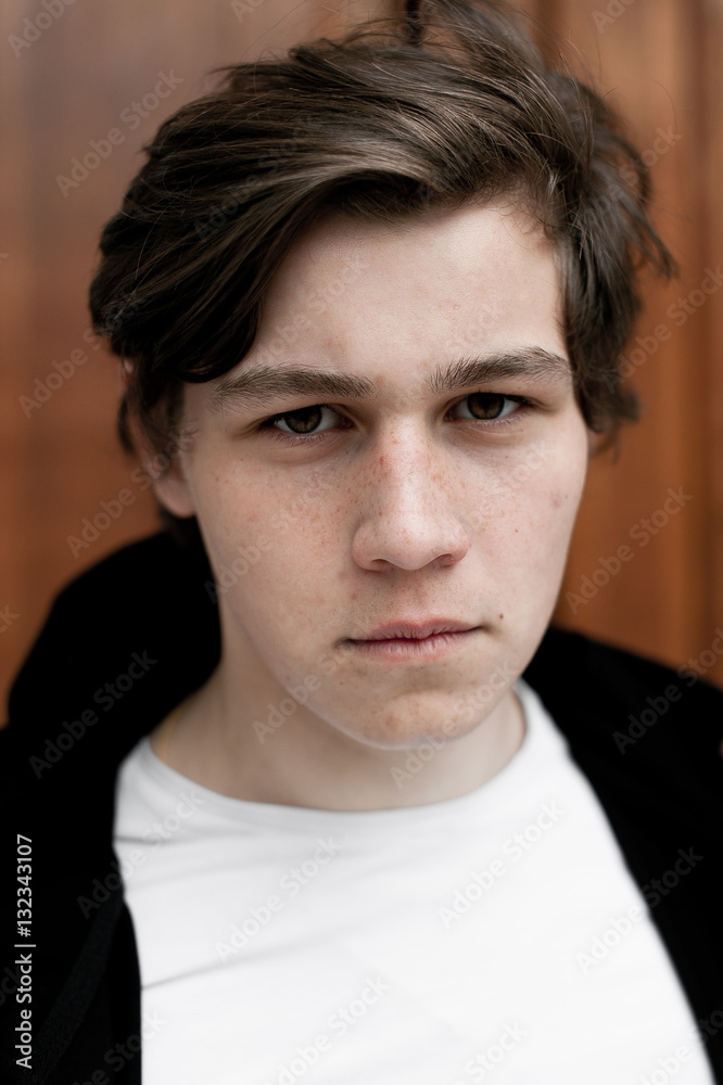 Fototapeta premium Young elegant trendy boy outdoors, wearing black and white clothing