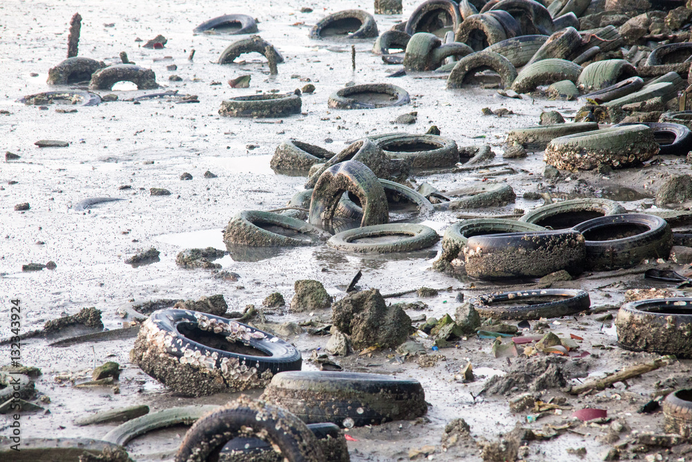 Fototapeta premium Dirty muddy beach showing a dump site