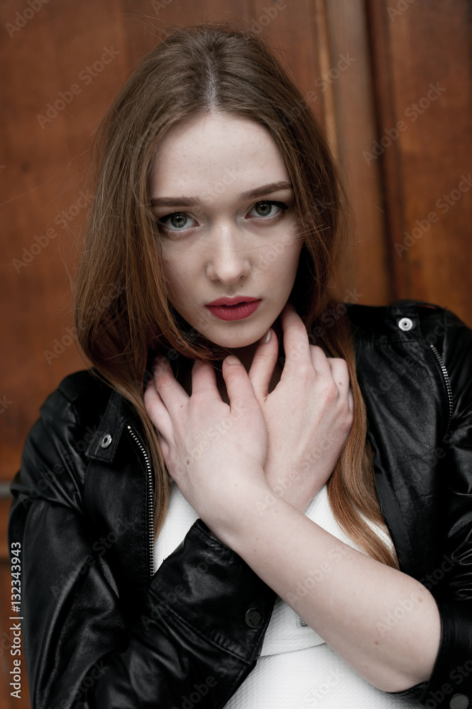 Fototapeta premium Young elegant trendy lady outdoors, wearing black and white clothing