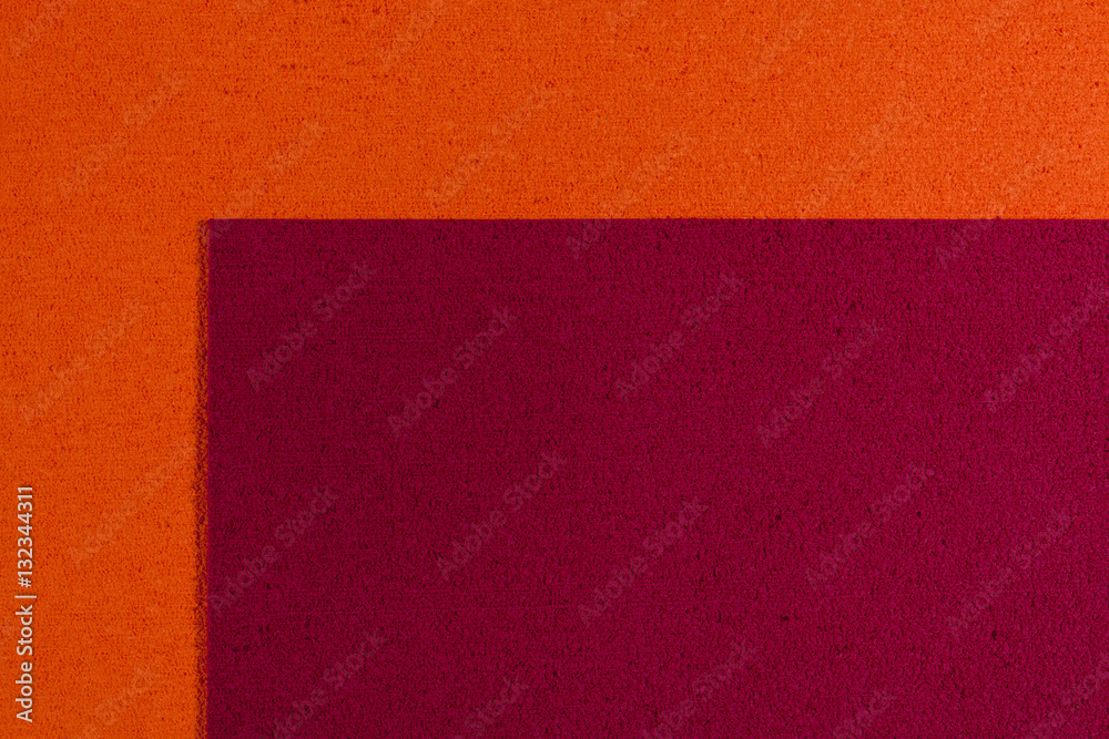 Fototapeta premium Eva foam ethylene vinyl acetate red surface on orange sponge plush background