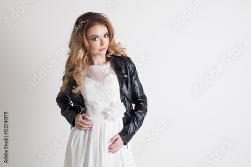 bride in white dress and leather jacket