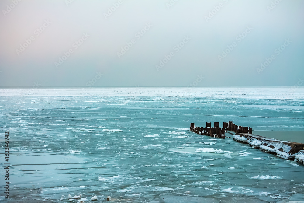 Pier in the winter sea. ice, overcast, nature background