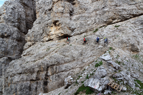People climbing the Via Ferrata Severino Casara in Sexten Dolomites mountains, South Tyrol, Italy
