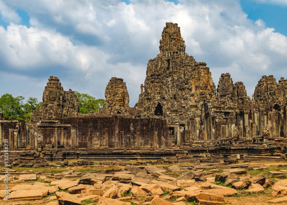 Prasat Bayon with smiling stone faces is the central temple of Angkor Thom Complex, Siem Reap, Cambodia. Ancient Khmer architecture and famous Cambodian landmark, World Heritage. Prasat Bayon with smiling stone faces is the central temple of Angkor Thom Complex, Siem Reap, Cambodia. Ancient Khmer architecture and famous Cambodian landmark, World Heritage.