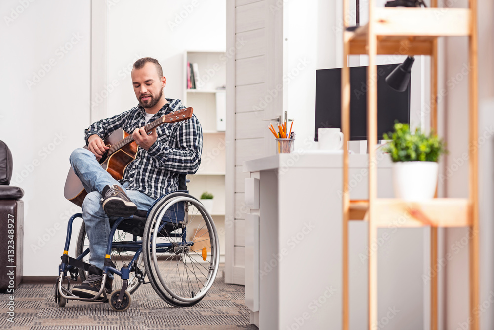 Devoted handicapped man playing musical instrument Devoted handicapped man playing musical instrument