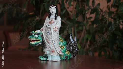 Antique statuette of an asian girl with the dragon. photo