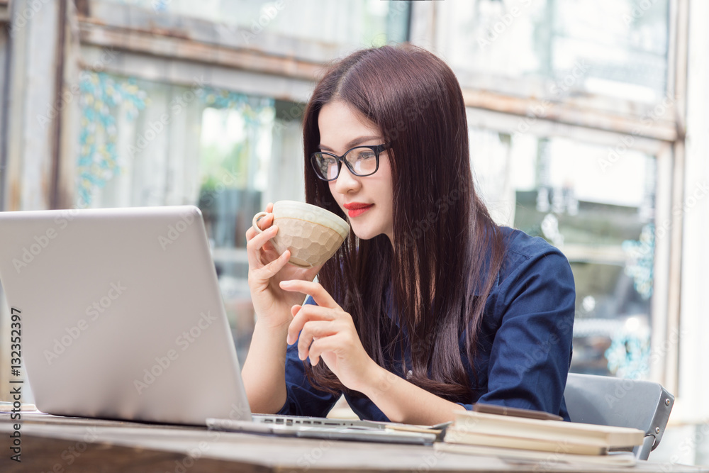 young asian woman using technology on her laptop computer and ho young asian woman using technology on her laptop computer and ho