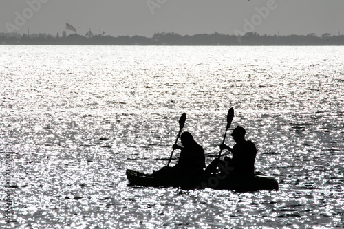 Silhouette Of Two People Rowing 