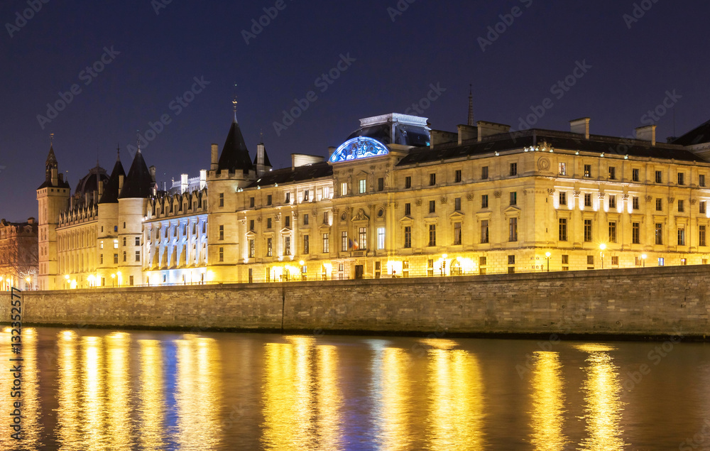 The Conciergerie castle at night, Paris, France.