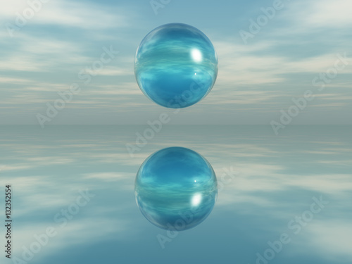 Esfera de cristal flotando sobre una superficie espejada