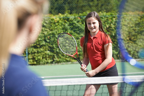 Female Tennis Coach Giving Lesson To Girl © highwaystarz