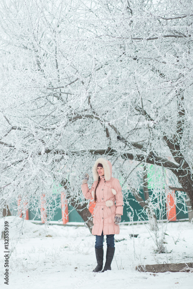 Girl standing under a tree. Winter. Girl standing under a tree. Winter.