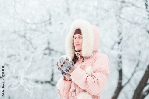 Young woman drinking tea in winter